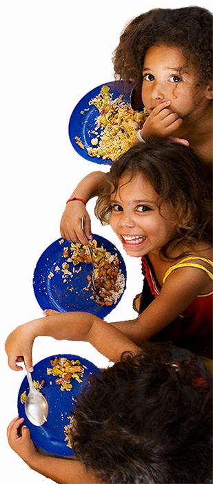 Girls at the school kitchen eating and smiling up to an aereal camera