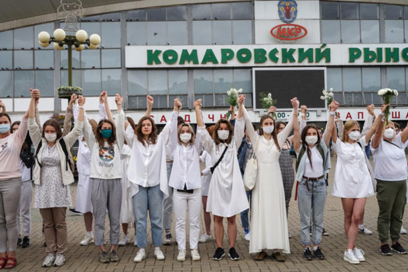 Women protesters hold hands in solidarity over the disputed presidential election in Belarus. Women protesters hold hands in solidarity over the disputed presidential election in Belarus.