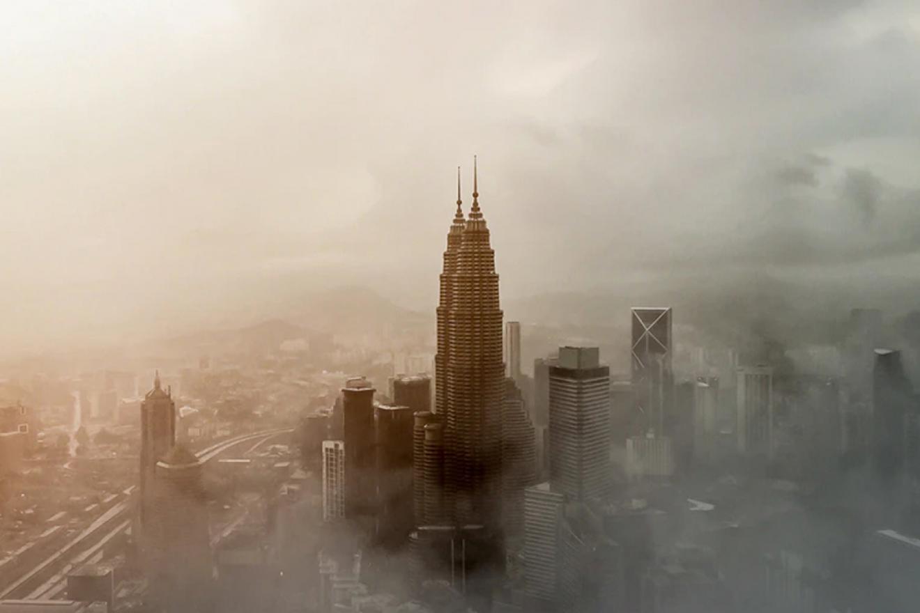 Skyscrapers surrounded by smog. 