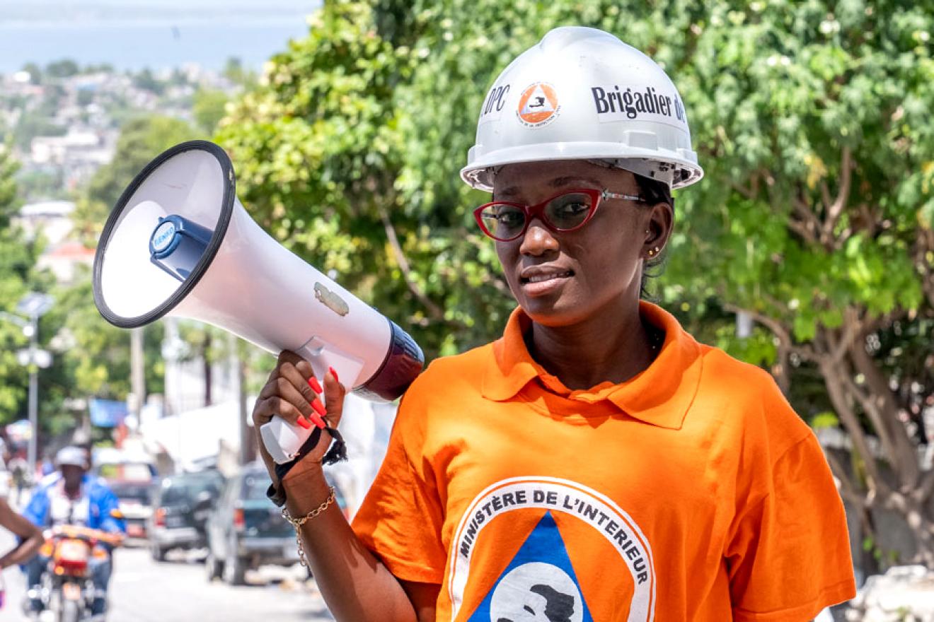 The portrait of a woman holding a megaphone. 