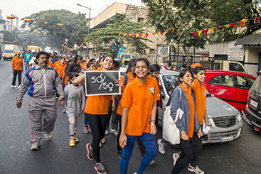 Youth dressed in orange march against gender violence